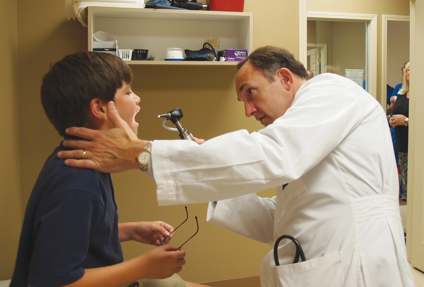 Dr. Alan DeJarnatt checks out an allergy patient. 